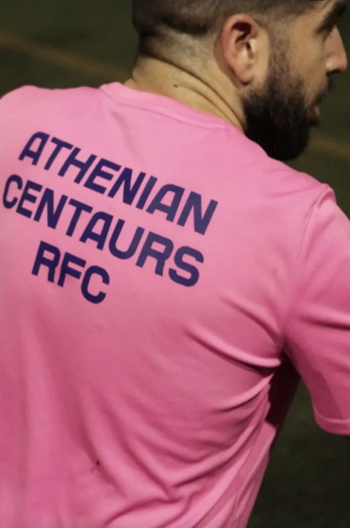 Person wearing a pink t-shirt with 'Athenian Centaurs RFC' text on the back.
